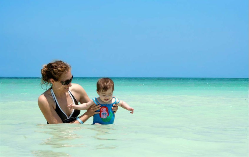 baby with mother swimming